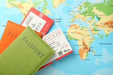 Photo of Passports with tickets on world map, top view