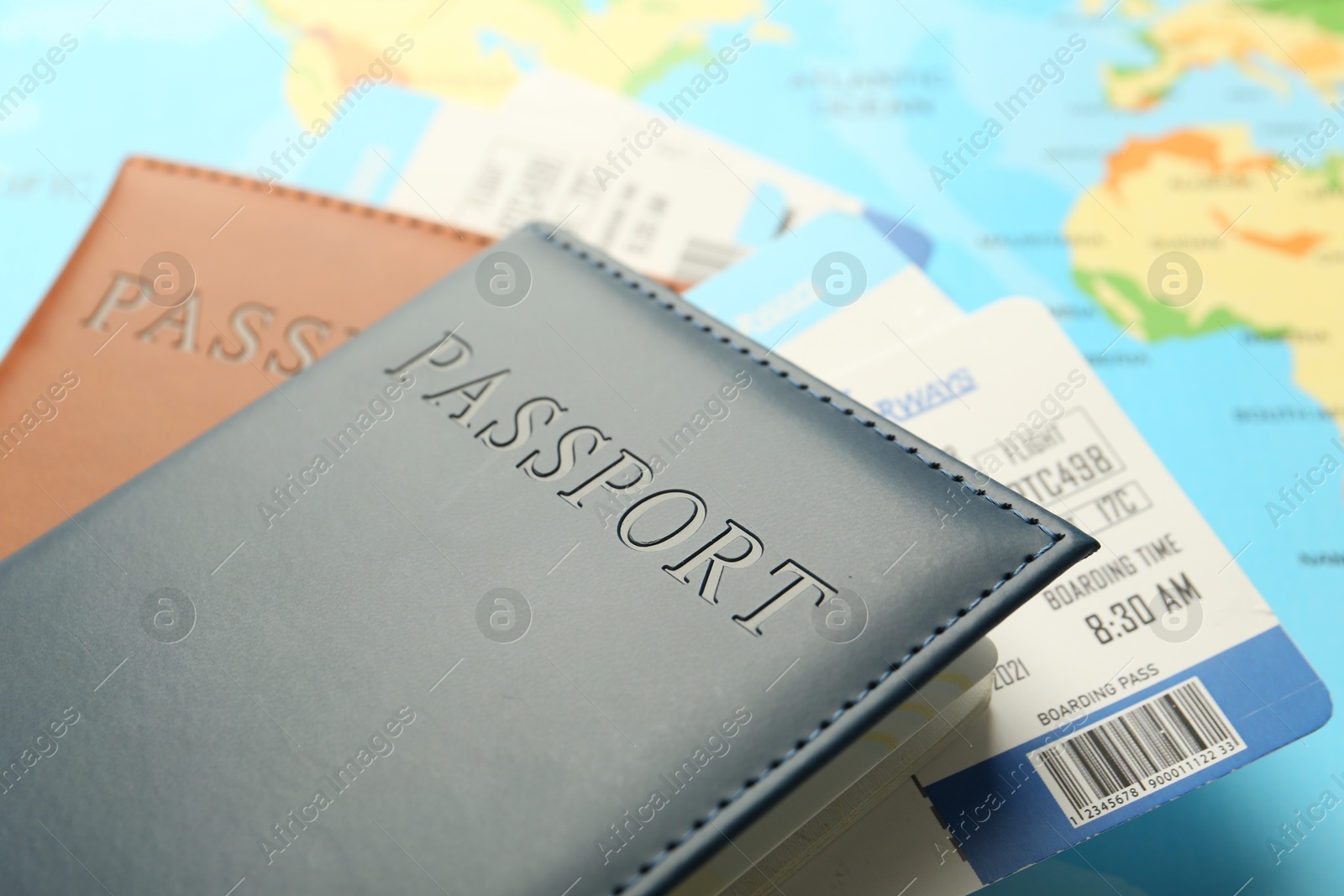 Photo of Passports with tickets on world map, closeup