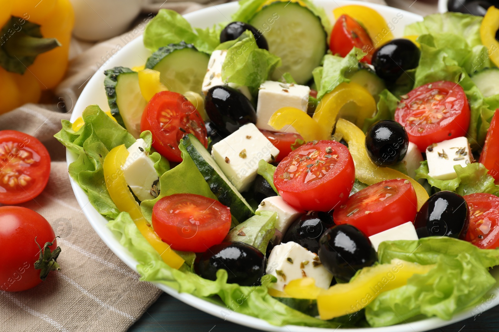 Photo of Delicious fresh Greek salad on table, closeup