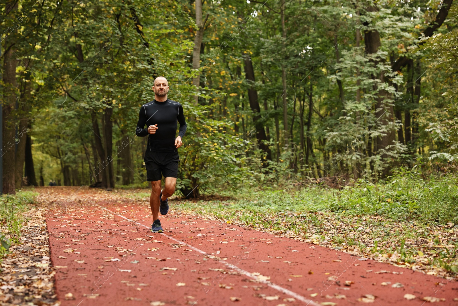 Photo of Athletic man running in park, space for text