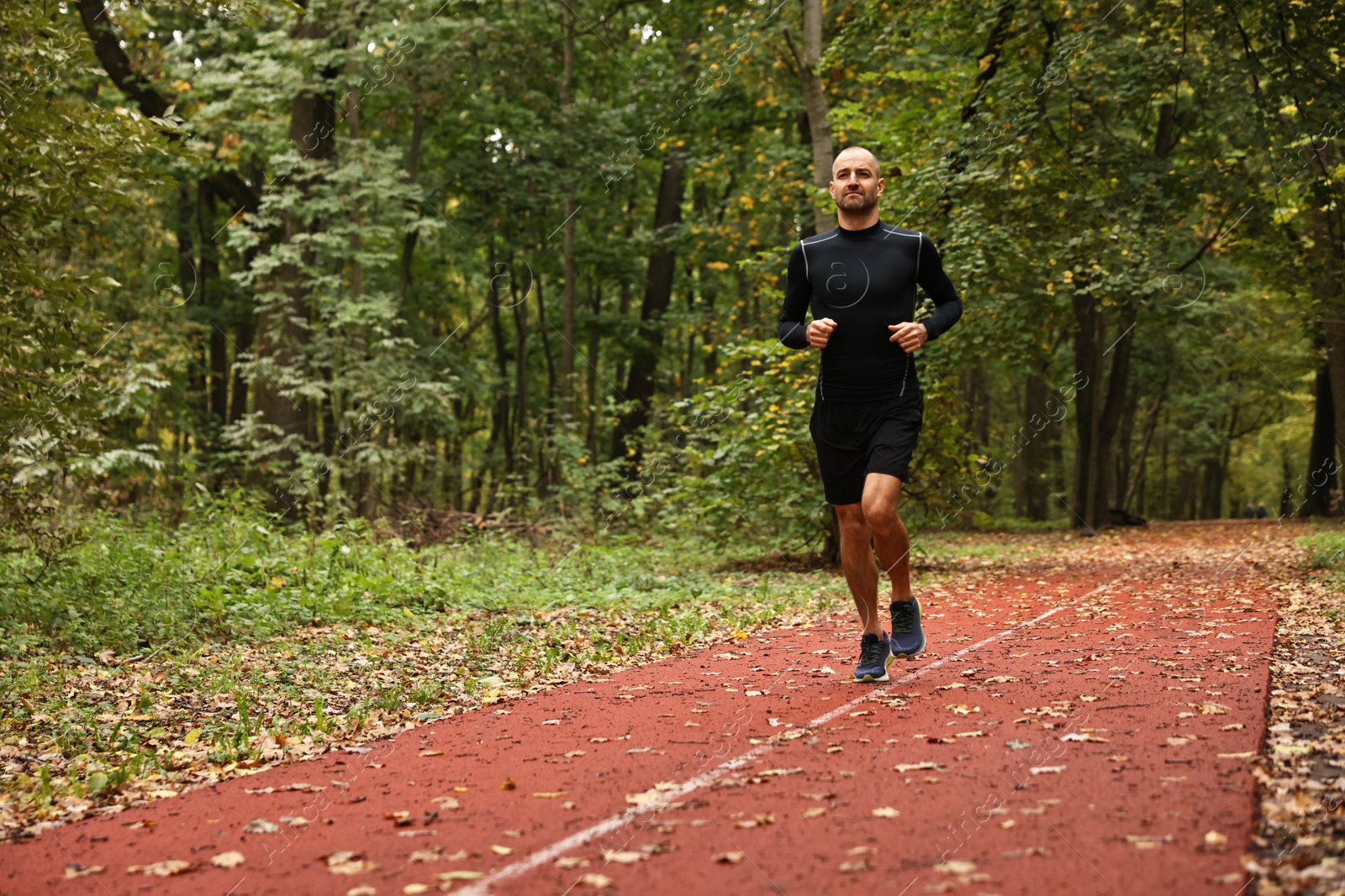 Photo of Athletic man running in park, space for text