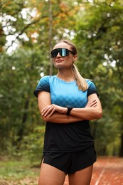 Photo of Portrait of young athletic woman in park