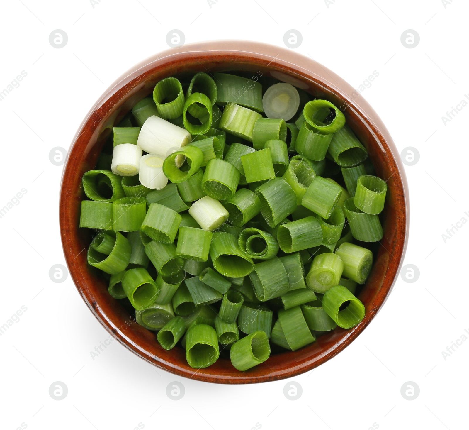 Photo of Chopped fresh green onion in bowl isolated on white, top view