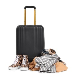 Photo of Suitcase and messy pile of clothes isolated on white