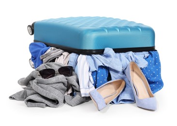 Photo of Packed suitcase full of clothes isolated on white