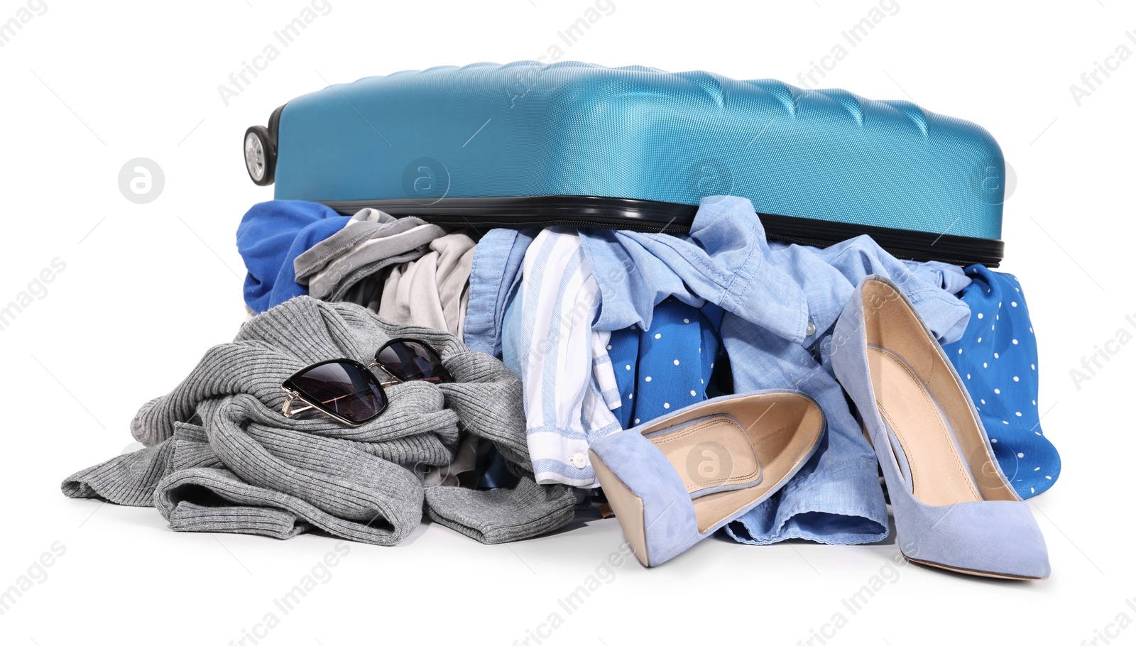 Photo of Packed suitcase full of clothes isolated on white