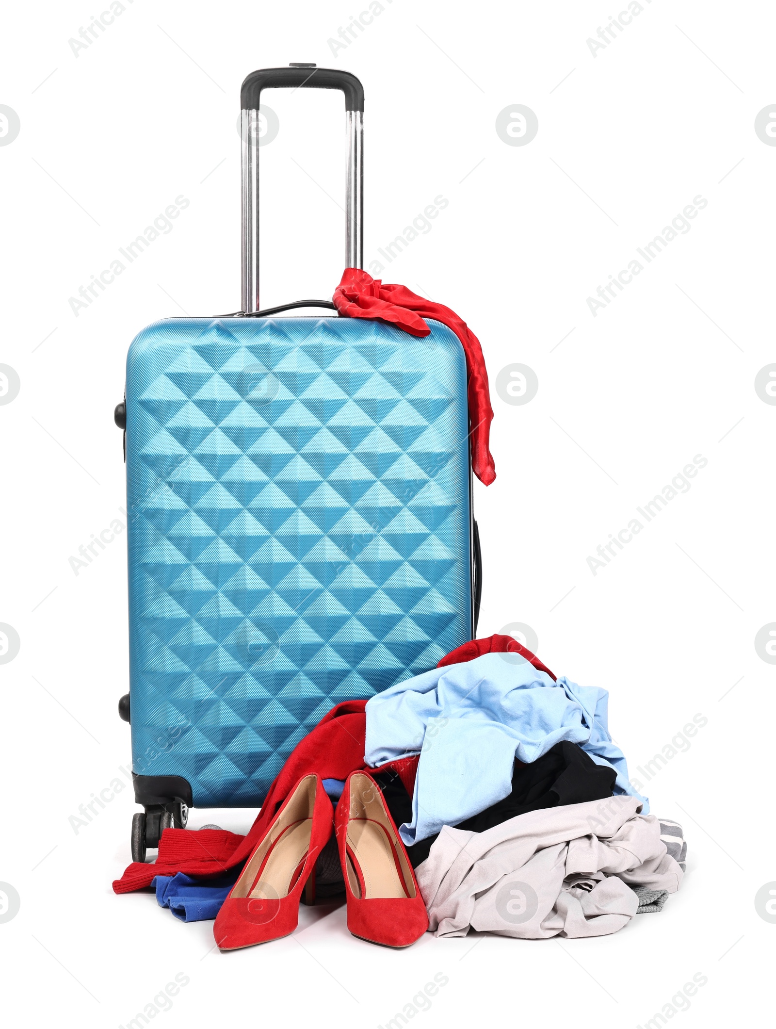 Photo of Suitcase and messy pile of clothes isolated on white