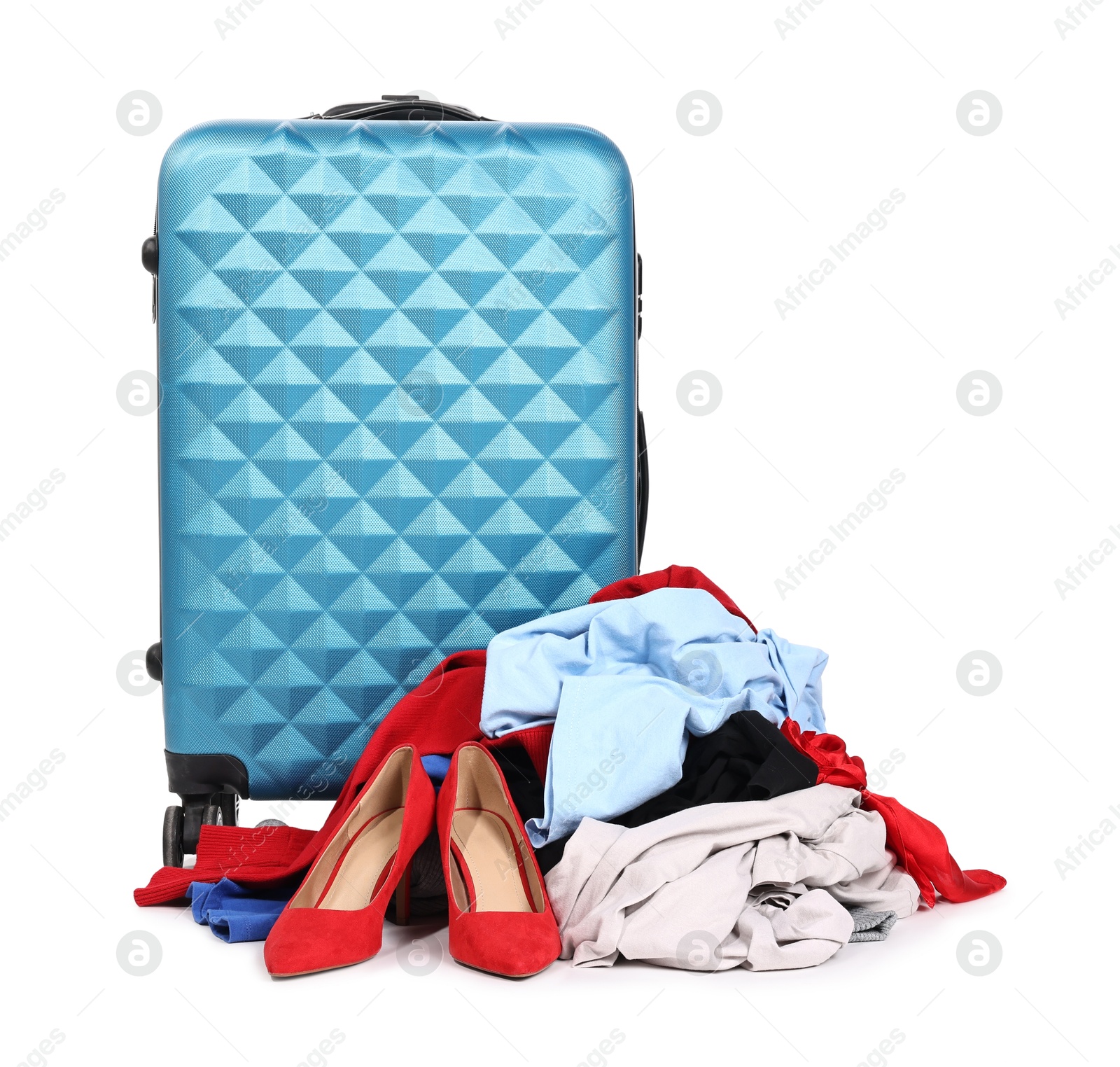 Photo of Suitcase and messy pile of clothes isolated on white