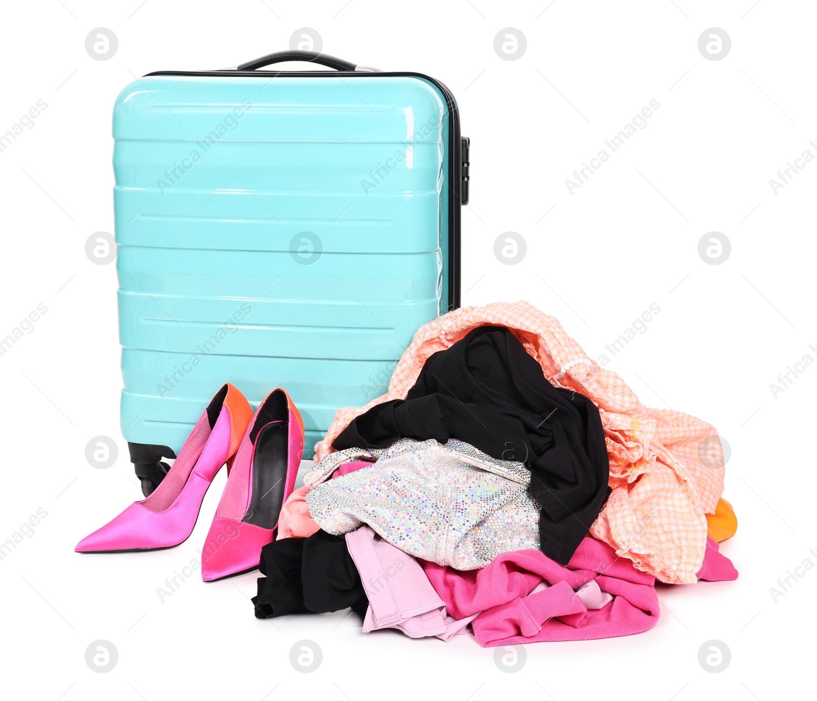 Suitcase and messy pile of clothes isolated on white Photo of Suitcase and messy pile of clothes isolated on white