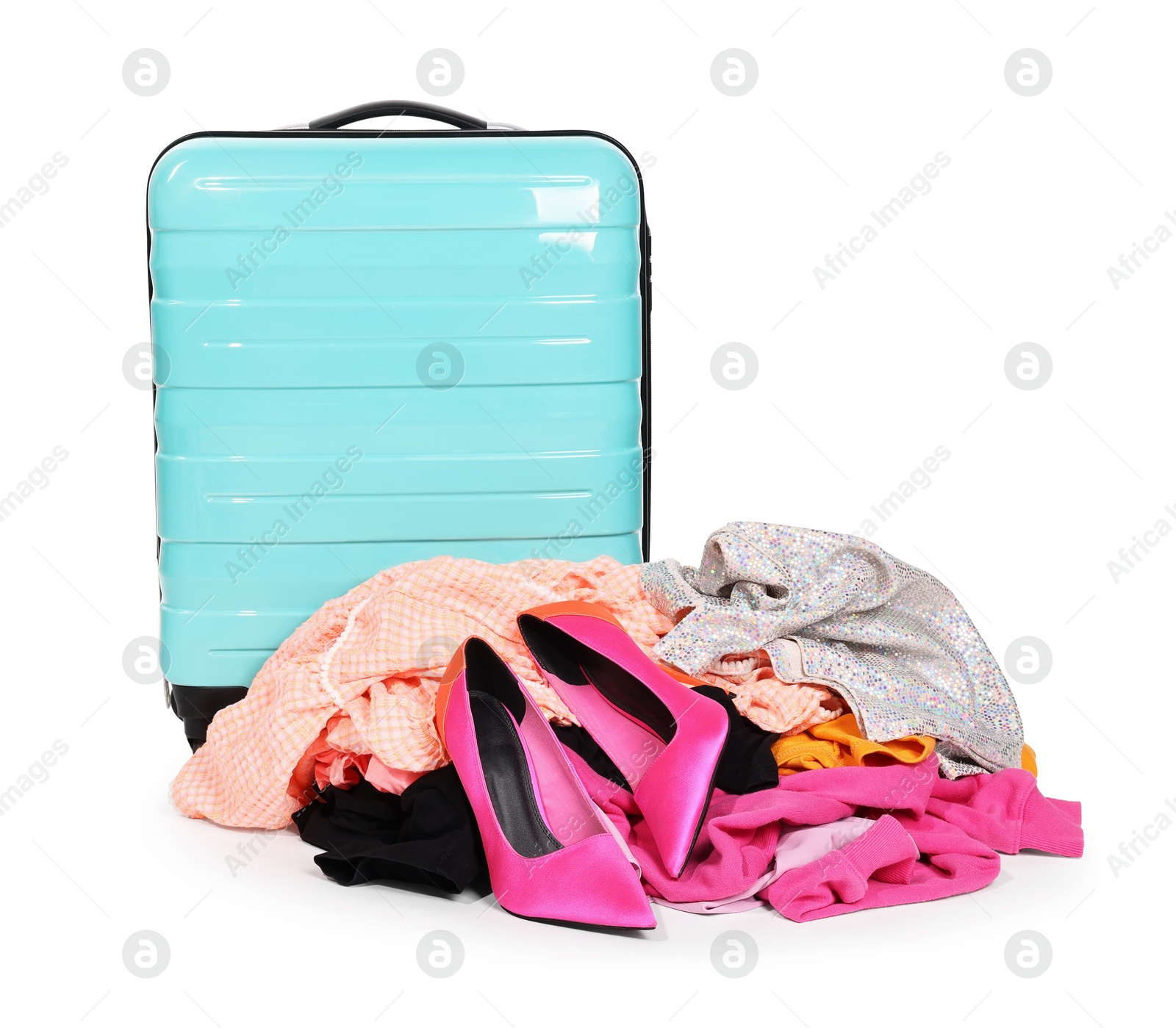 Suitcase and messy pile of clothes isolated on white Photo of Suitcase and messy pile of clothes isolated on white