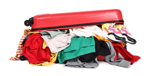 Photo of Packed suitcase full of clothes isolated on white