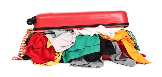 Photo of Packed suitcase full of clothes isolated on white