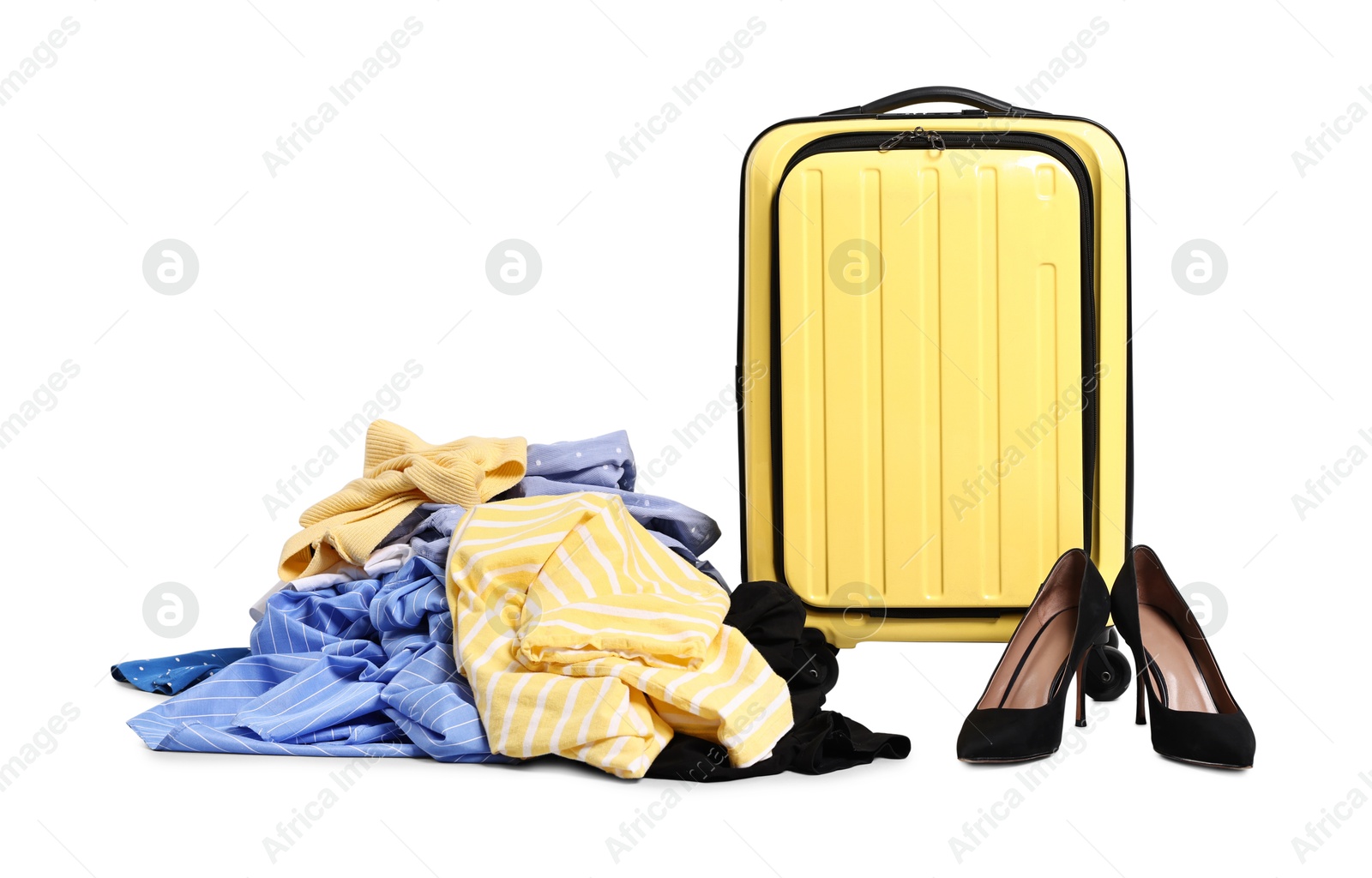 Photo of Suitcase and messy pile of clothes on grey background