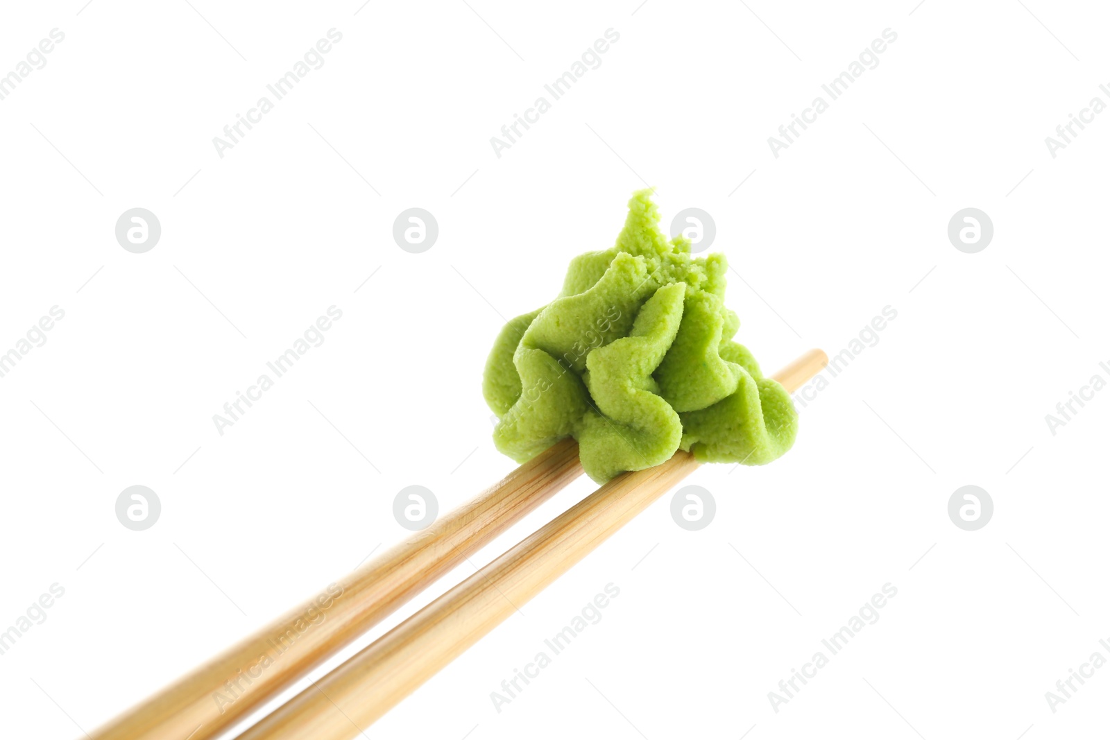 Photo of Chopsticks with hot wasabi paste isolated on white