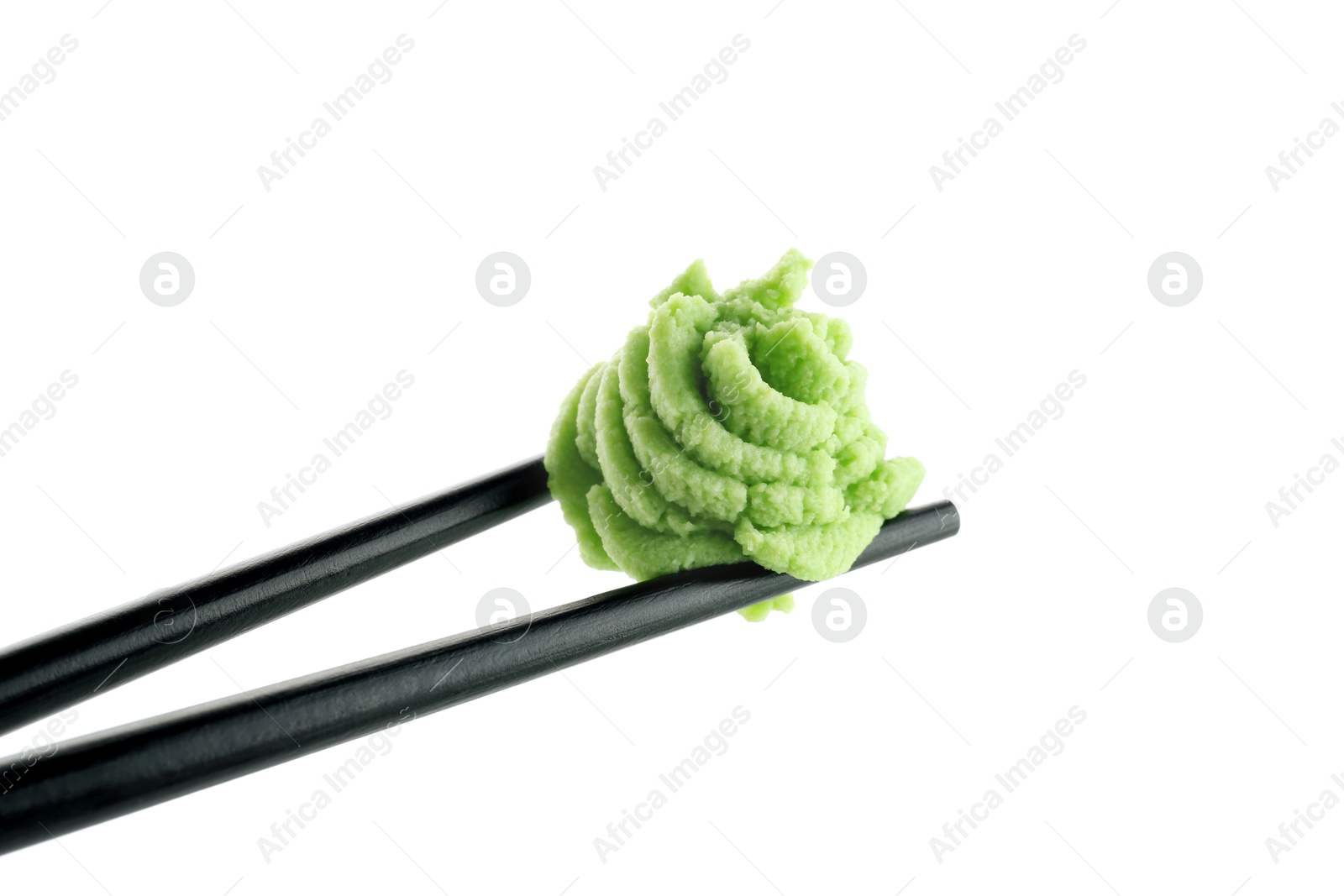 Photo of Chopsticks with hot wasabi paste isolated on white