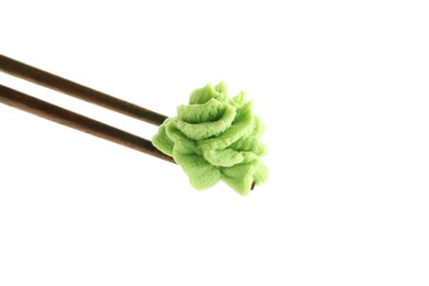 Photo of Chopsticks with hot wasabi paste isolated on white