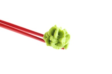 Photo of Chopsticks with hot wasabi paste isolated on white