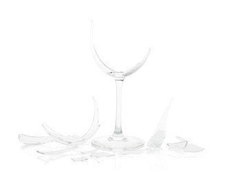 Photo of Pieces of broken wine glass isolated on white