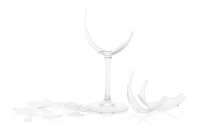 Photo of Pieces of broken wine glass isolated on white