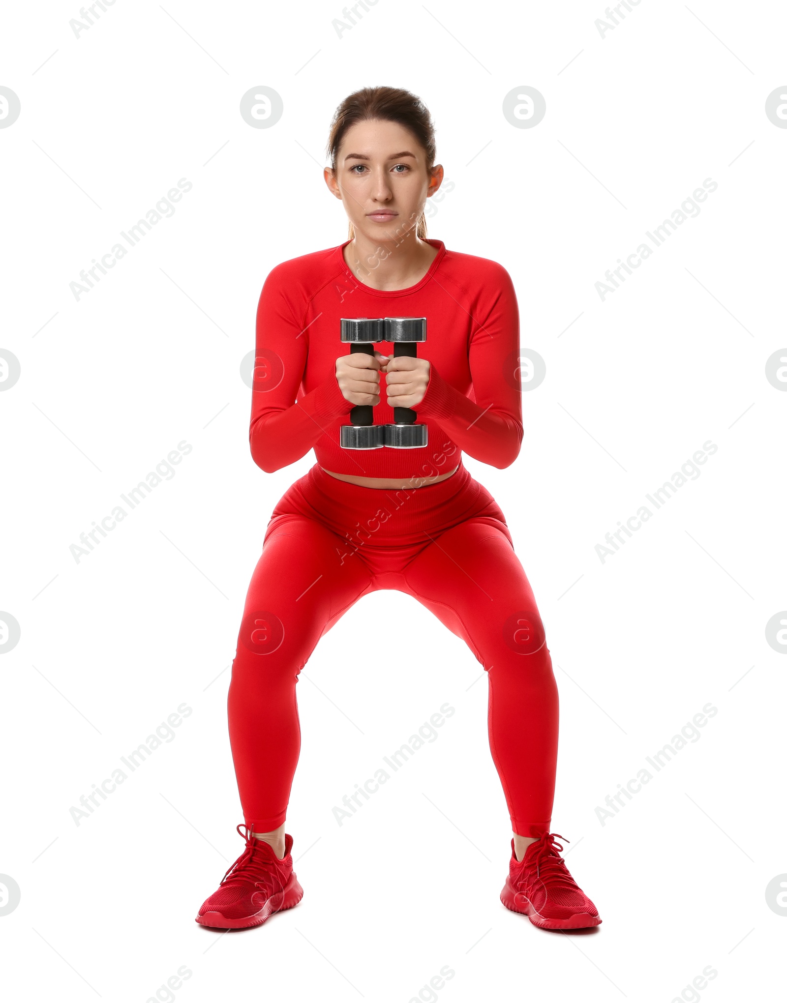 Photo of Woman in sportswear exercising with dumbbells on white background