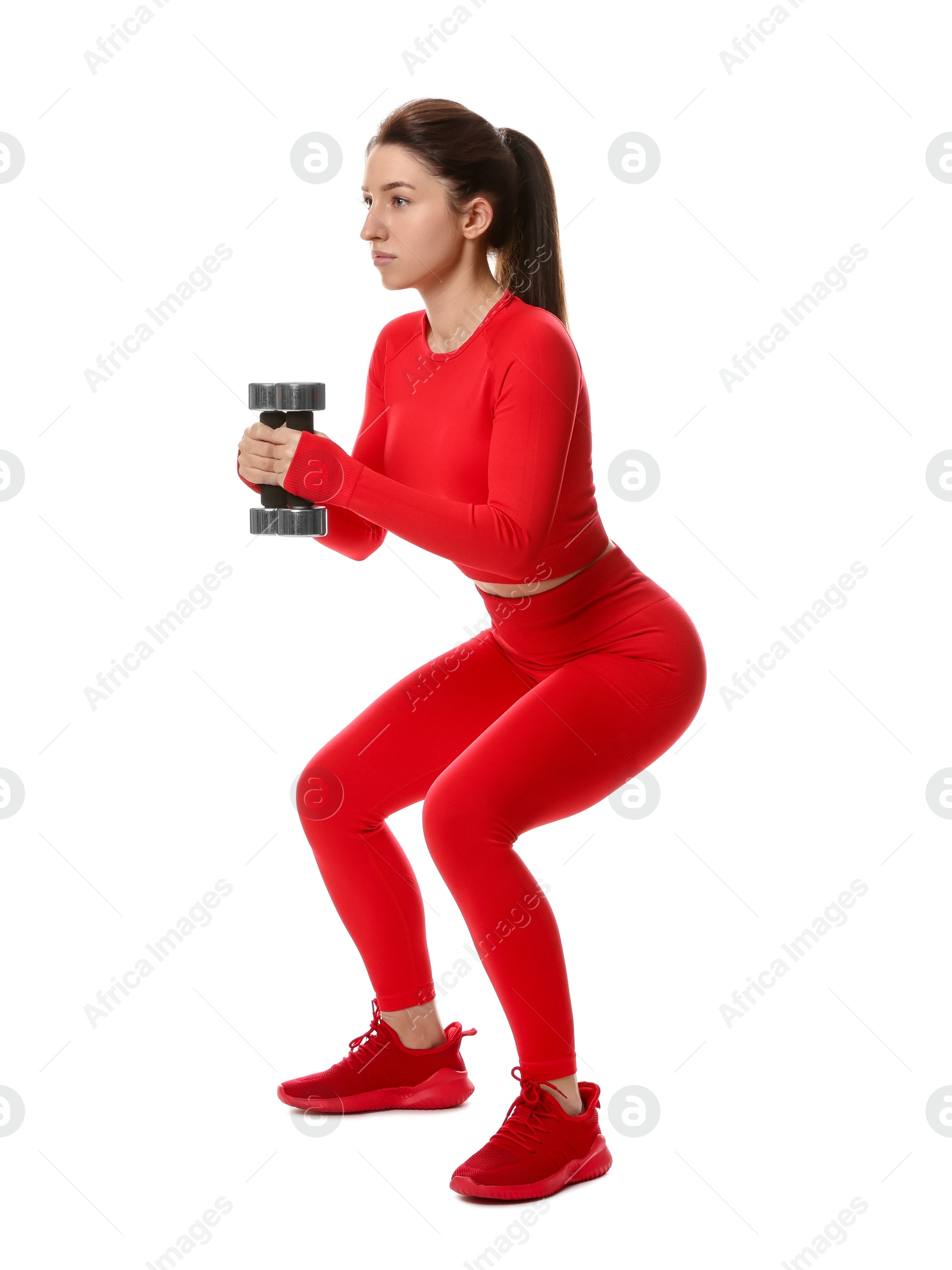 Photo of Woman in sportswear exercising with dumbbells on white background