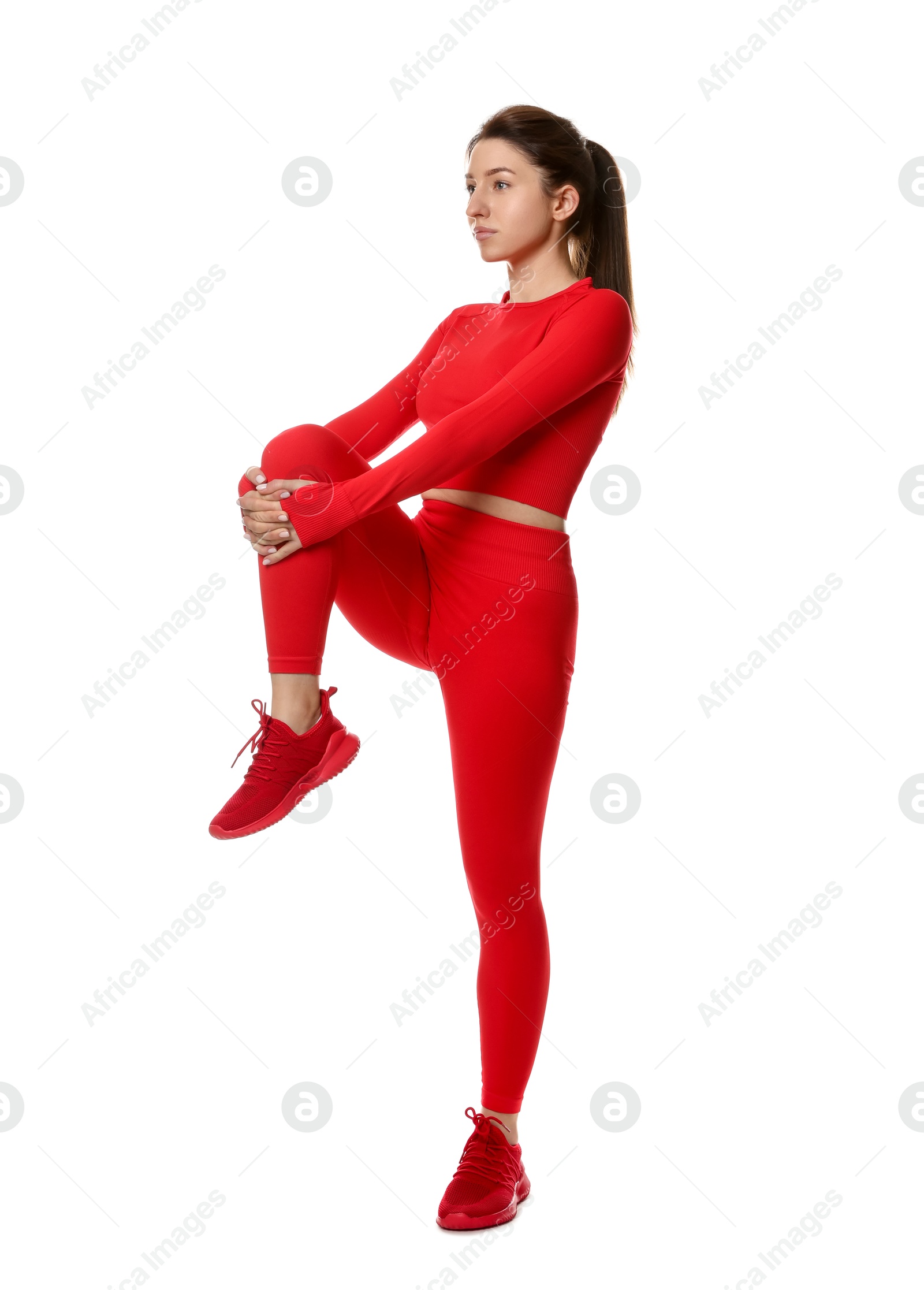 Photo of Woman in sportswear exercising on white background