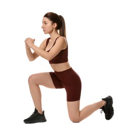 Photo of Woman in sportswear exercising on white background