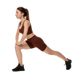 Woman in sportswear exercising on white background