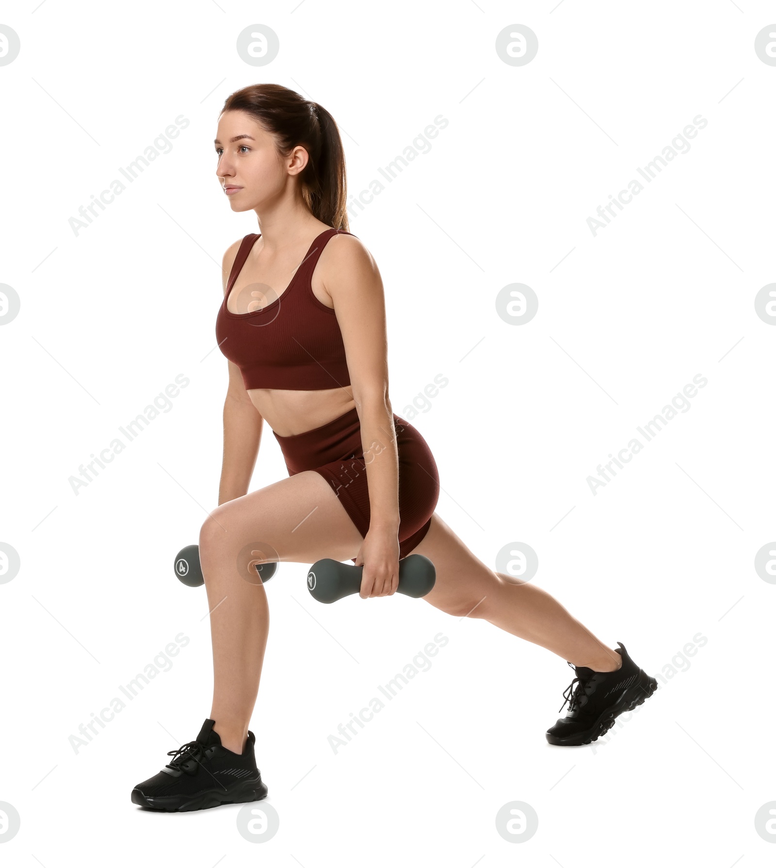 Photo of Woman in sportswear exercising with dumbbells on white background