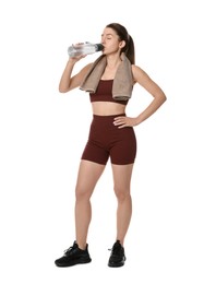 Photo of Woman in sportswear drinking water on white background