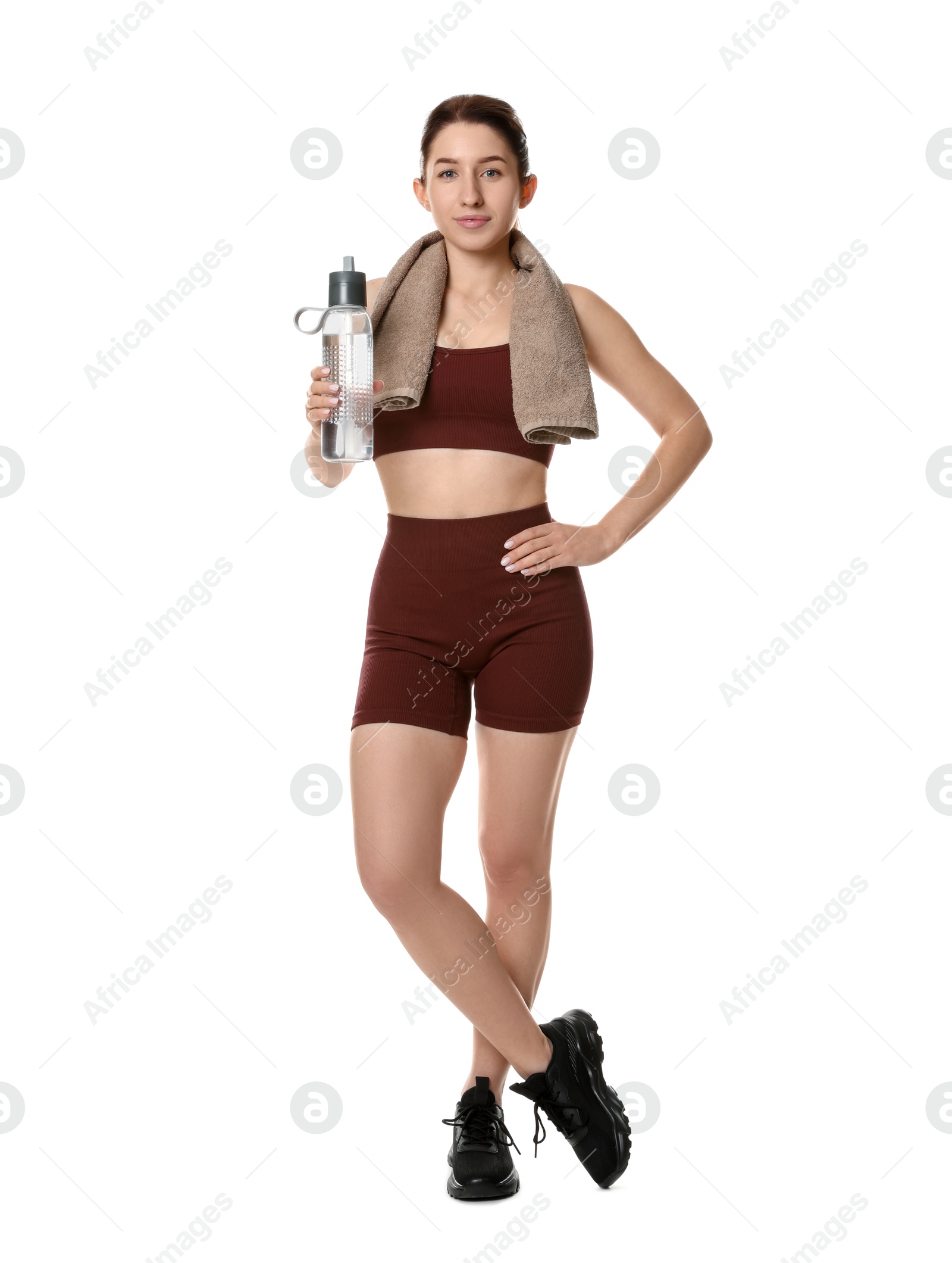 Photo of Woman in sportswear with bottle of water on white background