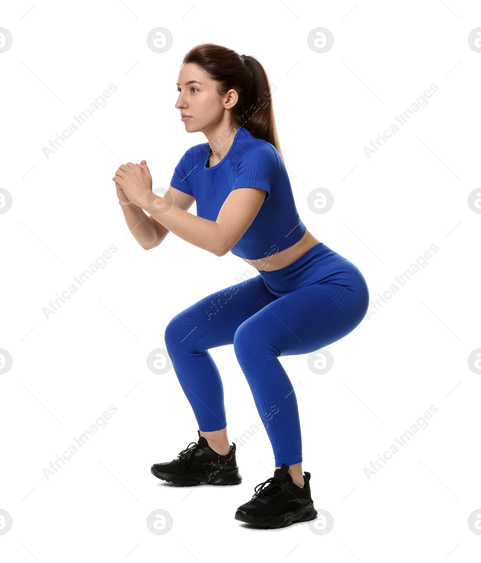 Photo of Woman in sportswear exercising on white background