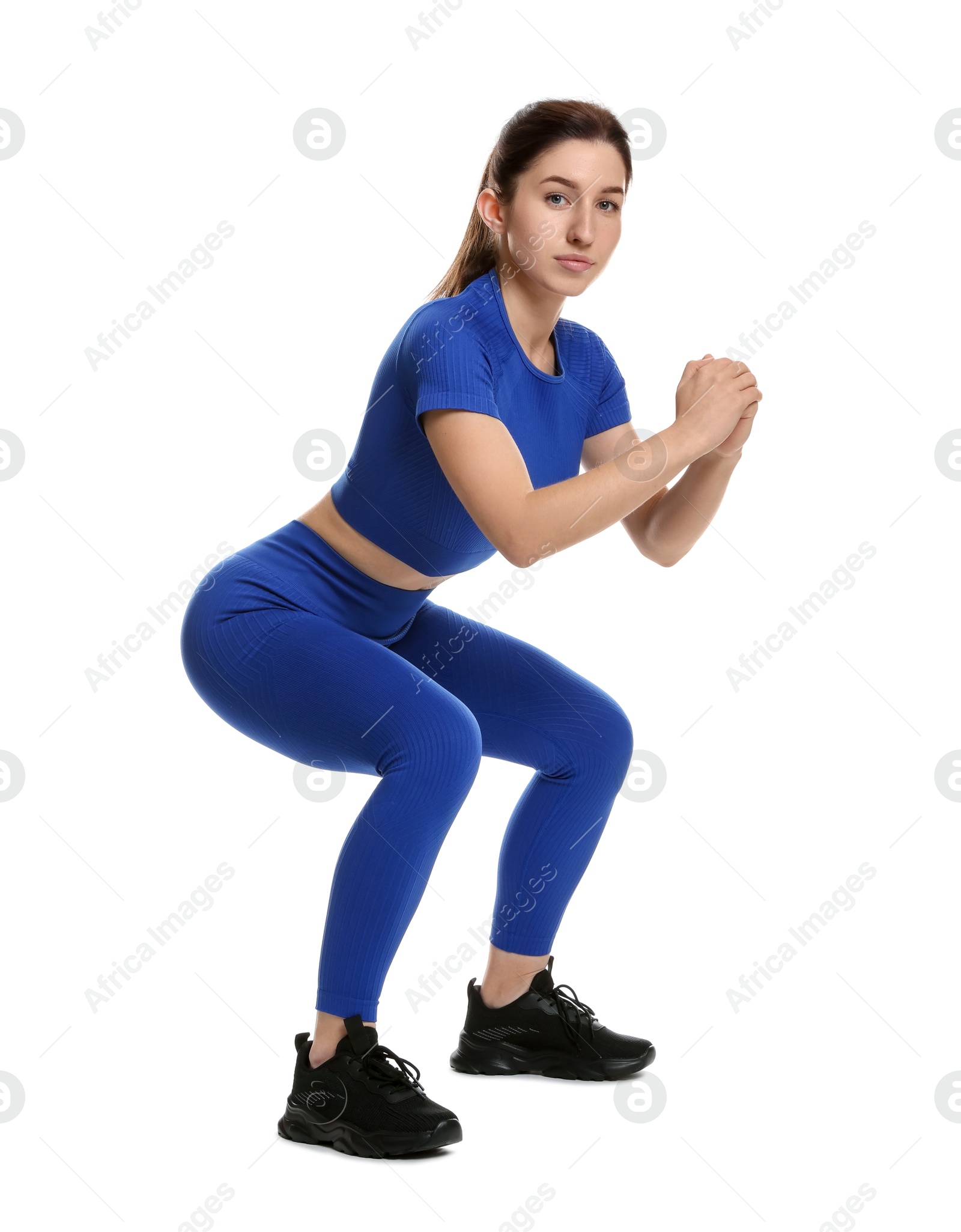 Photo of Woman in sportswear exercising on white background