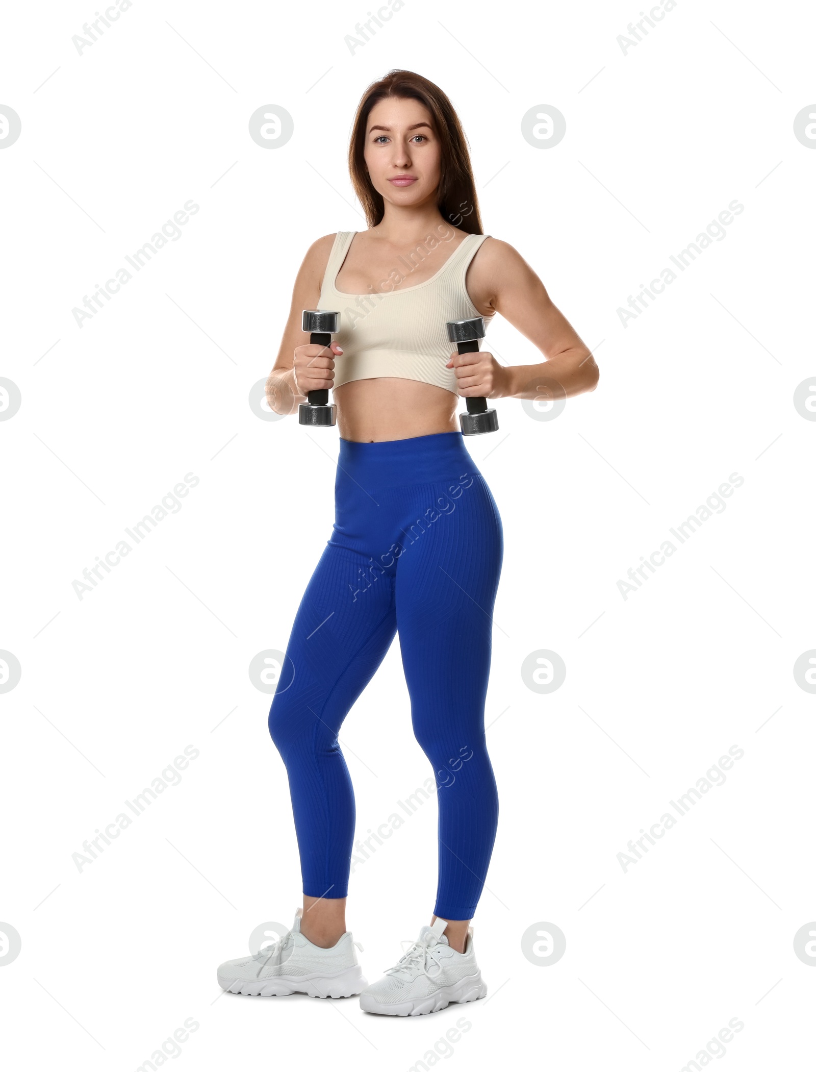 Photo of Woman in sportswear exercising with dumbbells on white background