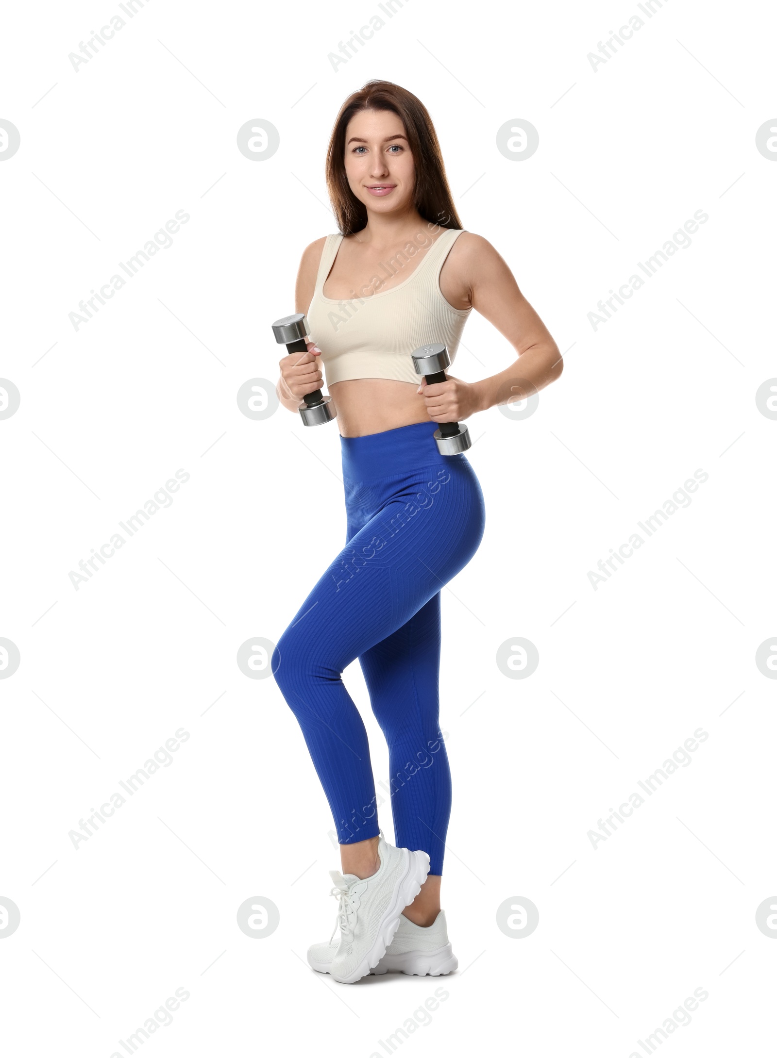 Photo of Woman in sportswear exercising with dumbbells on white background