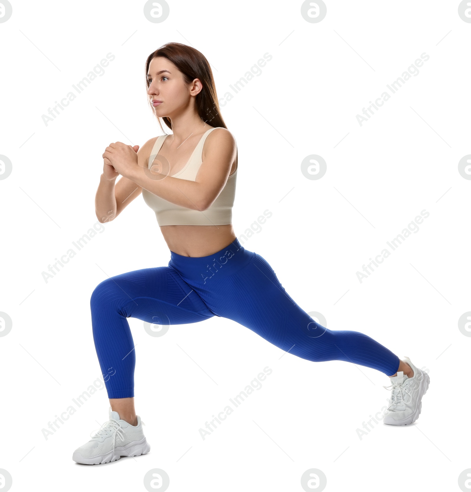 Photo of Woman in sportswear exercising on white background