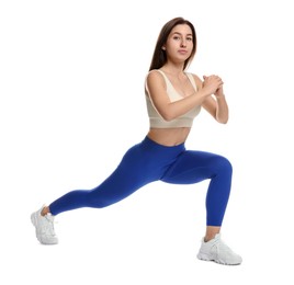 Photo of Woman in sportswear exercising on white background