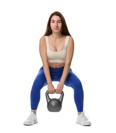 Photo of Woman in sportswear exercising with kettlebell on white background