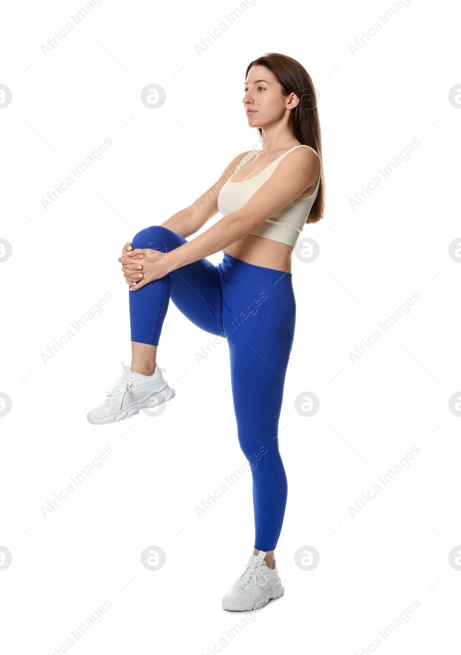 Photo of Woman in sportswear exercising on white background