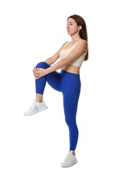 Photo of Woman in sportswear exercising on white background