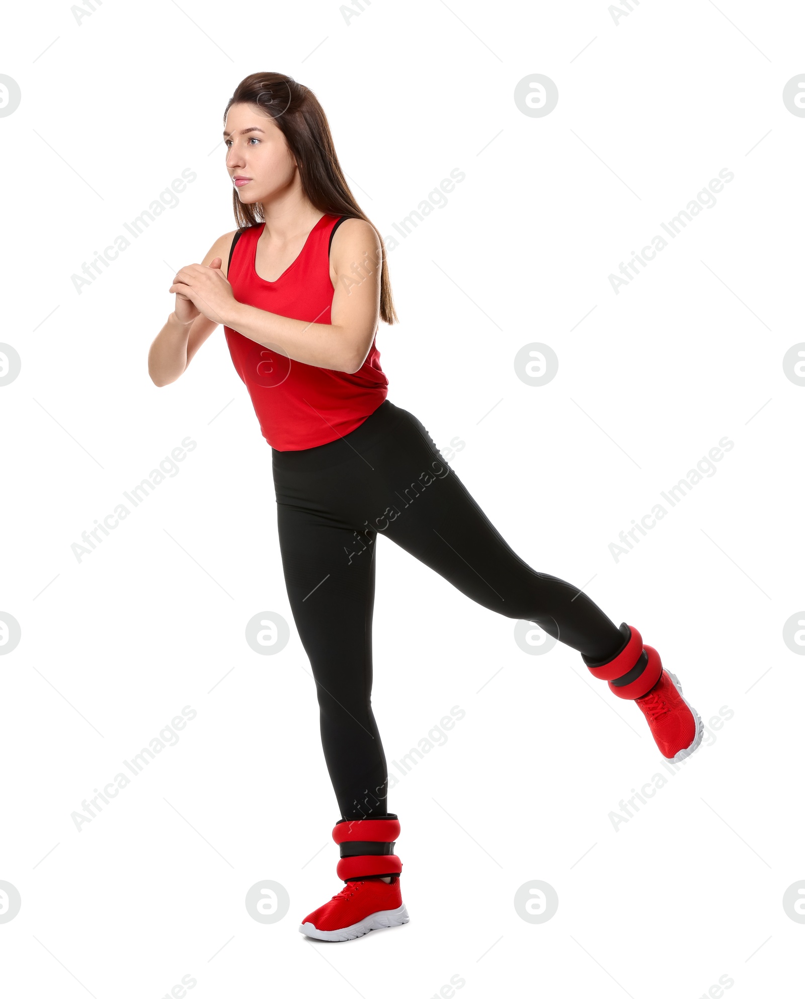 Photo of Woman in sportswear exercising with ankle weights on white background