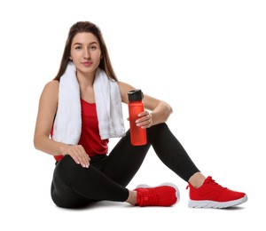 Woman in sportswear with bottle of water on white background