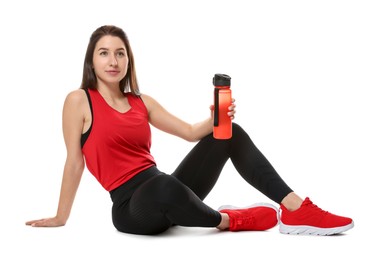 Woman in sportswear with bottle of water on white background