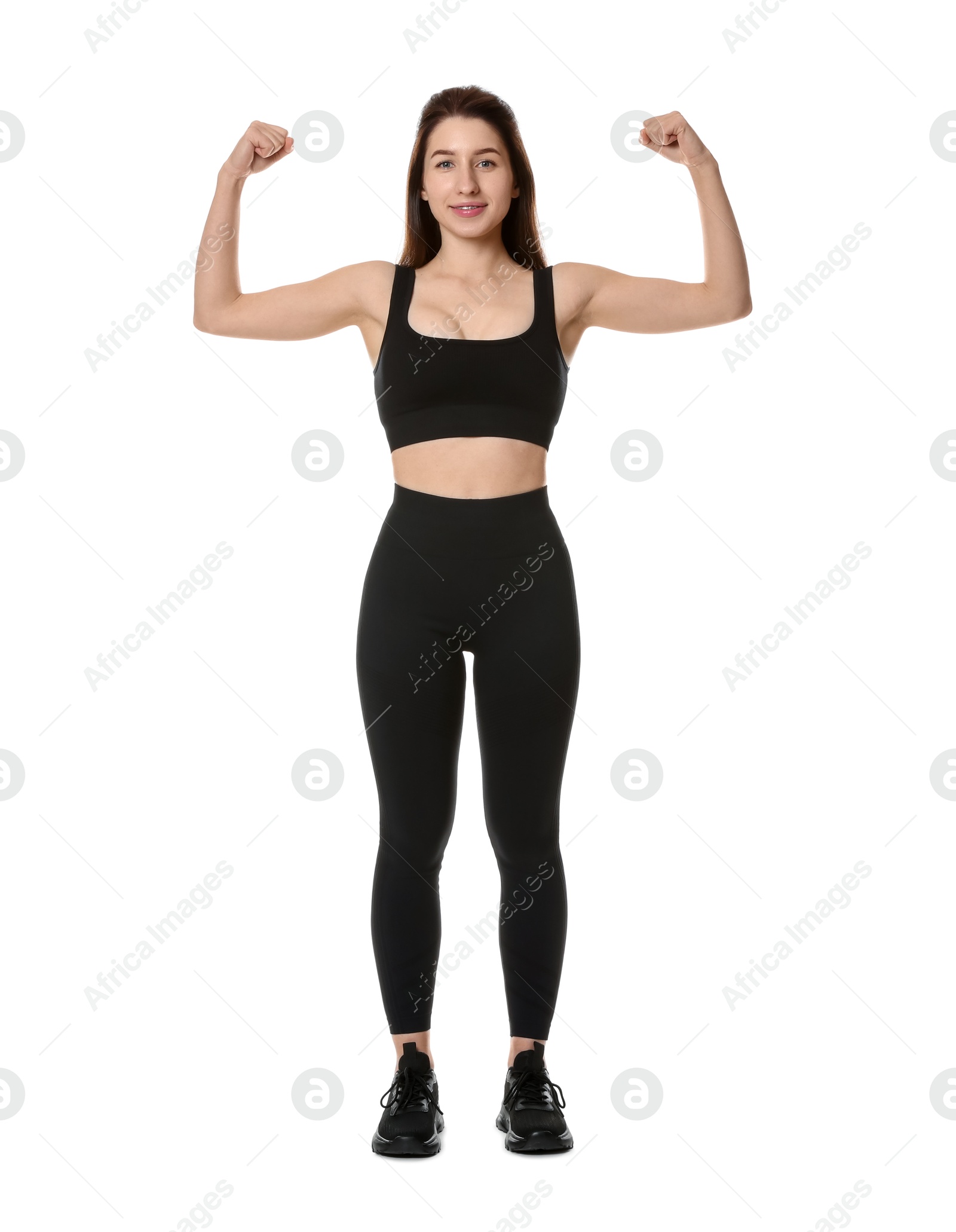 Photo of Woman in sportswear showing her biceps on white background