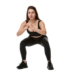 Woman in sportswear exercising on white background