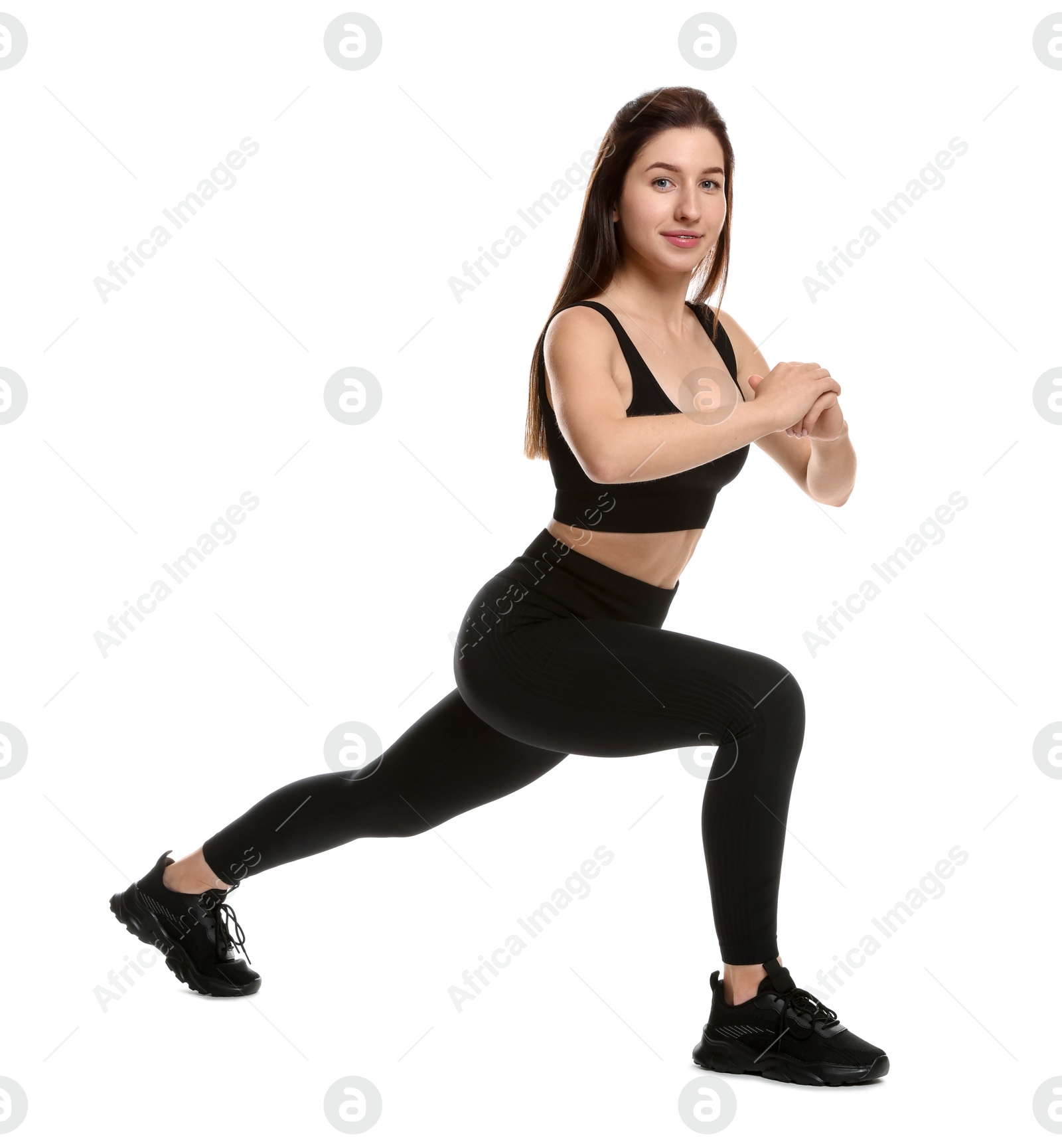 Photo of Woman in sportswear exercising on white background