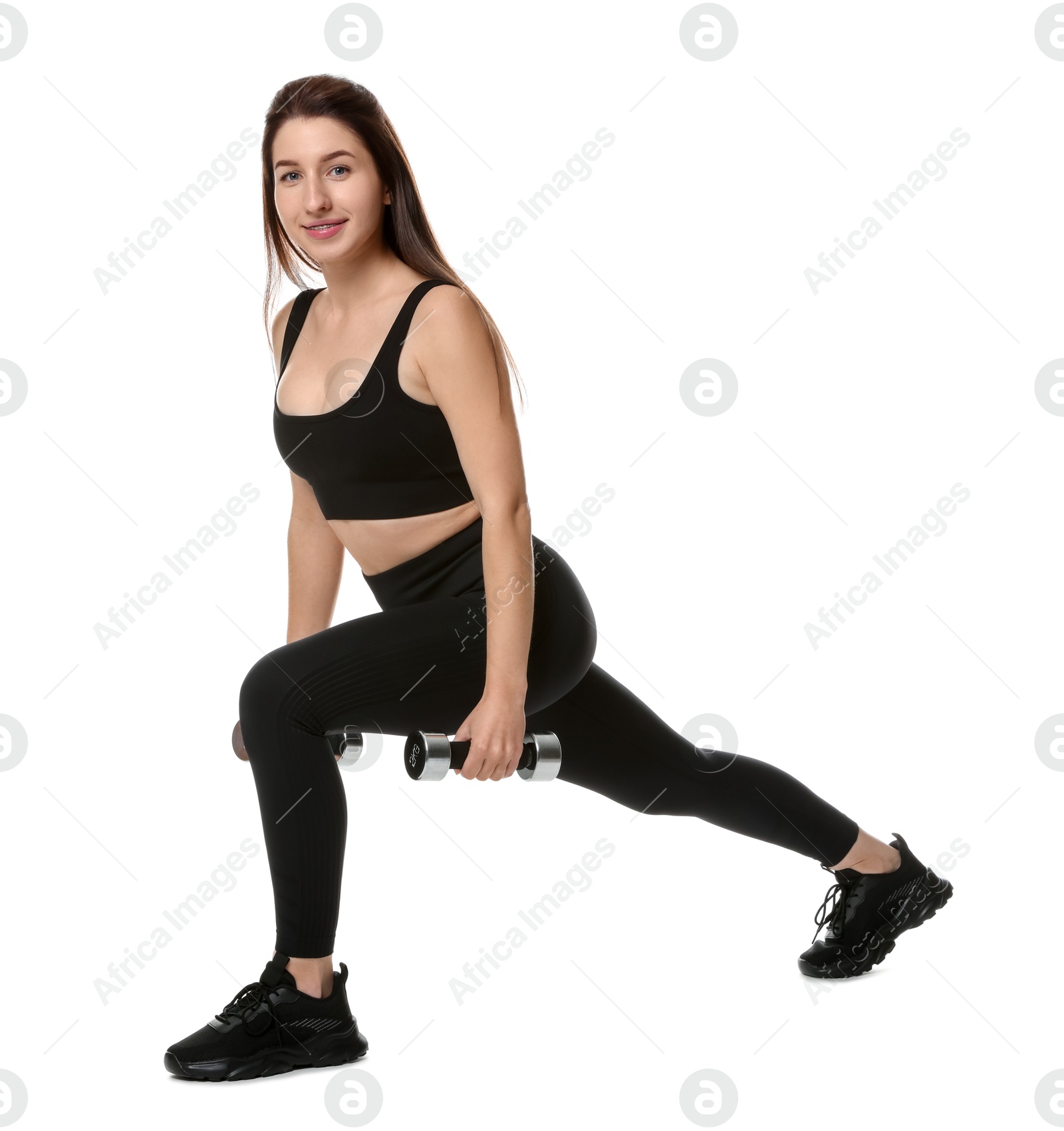 Photo of Woman in sportswear exercising with dumbbells on white background