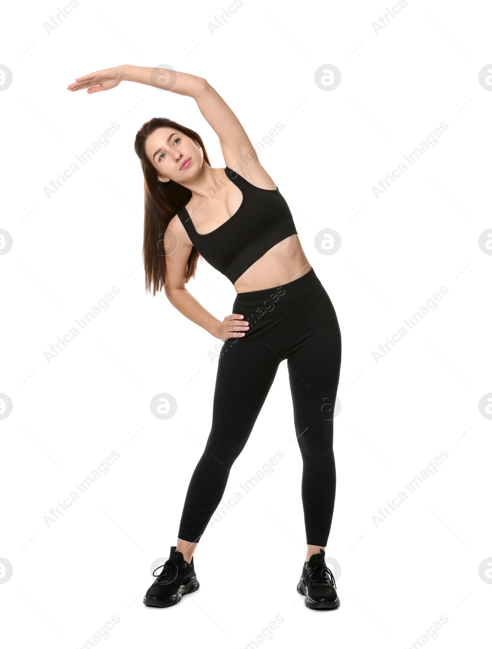 Photo of Woman in sportswear exercising on white background