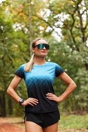 Photo of Portrait of young athletic woman in park