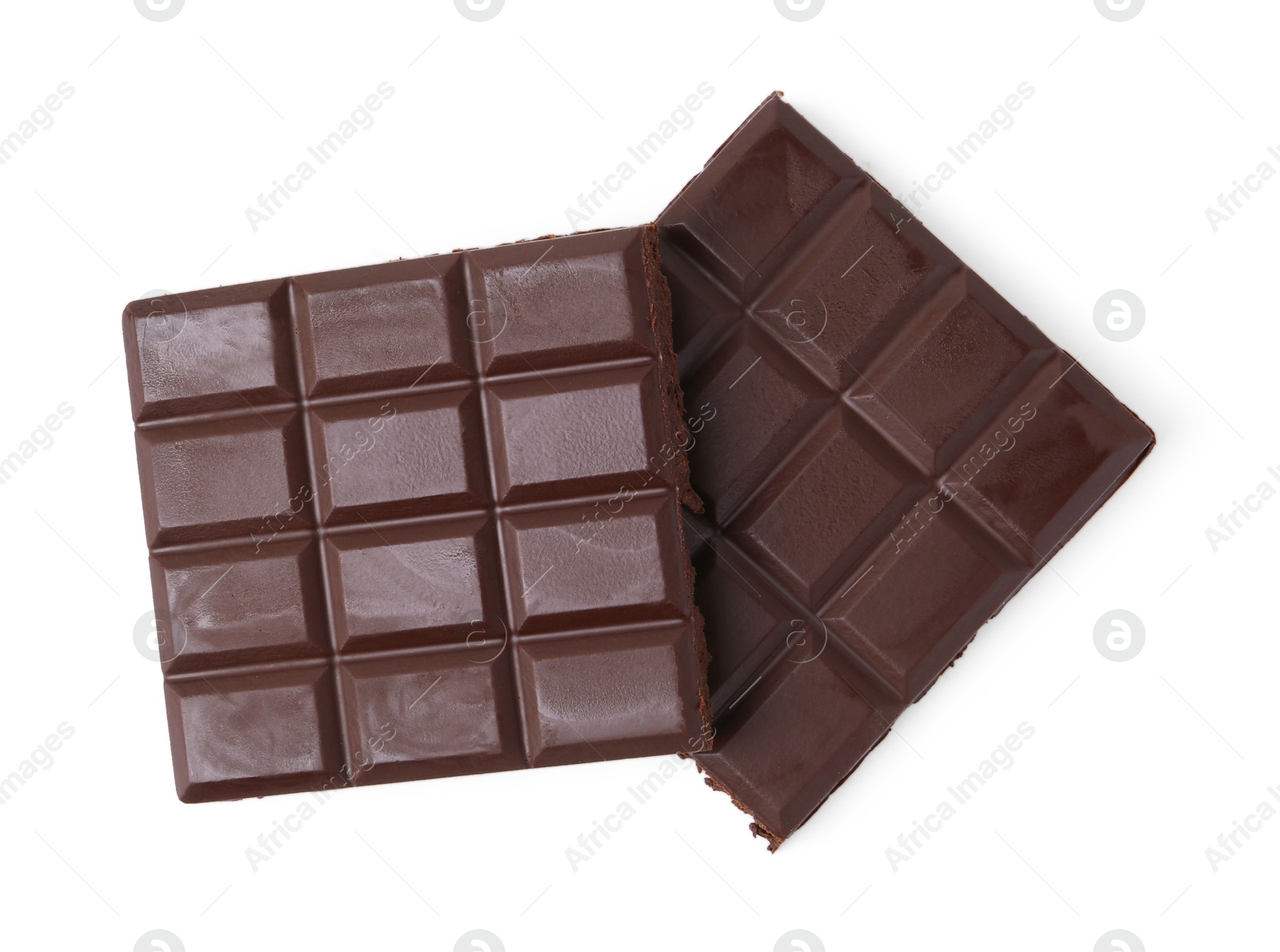 Photo of Pieces of delicious dark chocolate bar isolated on white, top view